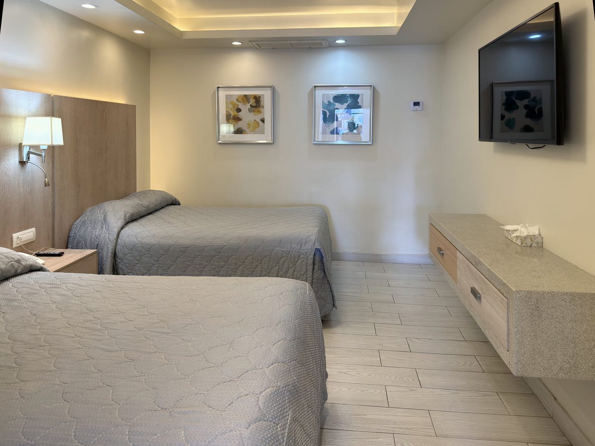 Junior Suite: two beds, granite credenza and wall-mounted TV